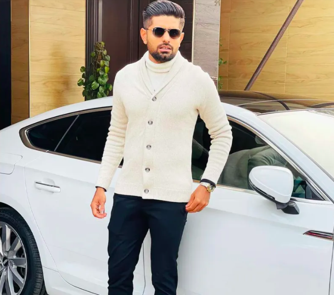 Babar Azam posing in front of his car 